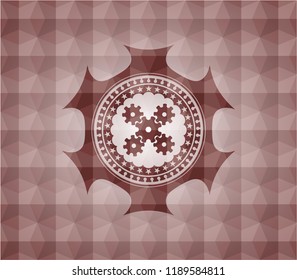 mechanism icon inside red seamless badge with geometric background.