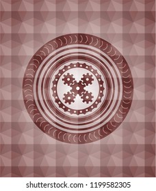 mechanism icon inside red seamless badge with geometric pattern background.