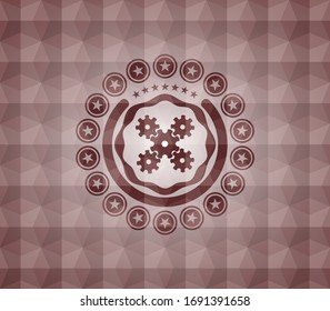 mechanism icon inside red seamless badge with geometric background.