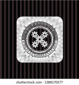 mechanism icon inside silver emblem or badge