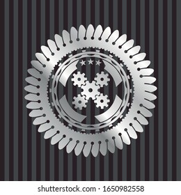 mechanism icon inside silver emblem or badge