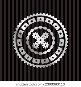 mechanism icon inside silver emblem or badge. 