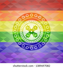 mechanism icon on mosaic background with the colors of the LGBT flag
