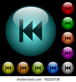 Media fast backward icons in color illuminated spherical glass buttons on black background. Can be used to black or dark templates
