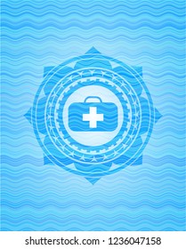 medical briefcase icon inside sky blue water emblem.