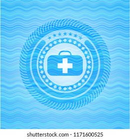 medical briefcase icon inside water wave style emblem.