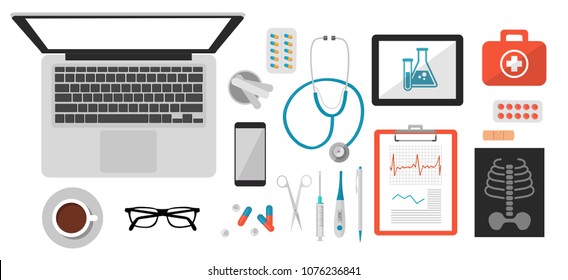 medical isolated objects, vector flat illustration of doctor's desk on which lies laptop, stetoscope, coffee, glasses, spatula, first-aid kit, syringe, thermometer, plaster, tablets, scissors, tablet,