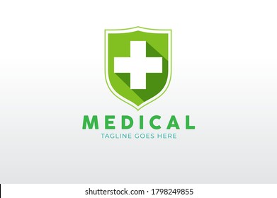 Medical Logo, Green shield Icon with cross inside isolated on White Background. Flat style Logo Design Template, vector illustration
