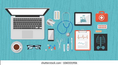 medical objects, doctor's desk, table: laptop, stethoscope, tablet, phone, first-aid kit, pen, prescription, scissors, syringe, thermometer, plaster, pills, medical spatula, glasses, X-ray,