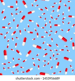 Medical seamless pattern, texture of red and white medicinal oval pharmaceutical beautiful tablets, capsules, vitamins, drugs, antibiotics isolated on a blue background. Concept: health care