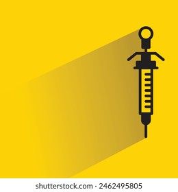 medical syringe icon with shadow on yellow background