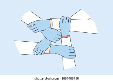 Medical Teamwork, Health Worker Unity Concept. Hands Of Doctors In Protective Gloves Holding Each Other Global Healthcare Partnership And Uniting Efforts Against Pandemic Of COVID-19