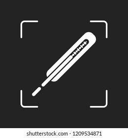Medical thermometer for body. White object in camera autofocus on dark background