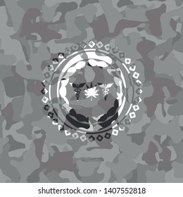 medicinal weed icon inside grey camouflaged emblem
