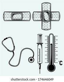 Medicine concept. Stethoscope, syringe and adhesive bandage. Image isolated on blue background