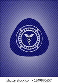 medicine icon inside badge with denim background