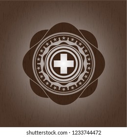 medicine icon inside badge with wood background