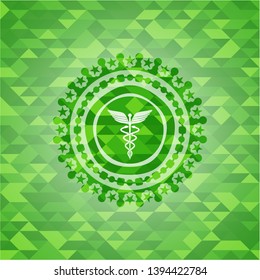 medicine icon inside green mosaic emblem
