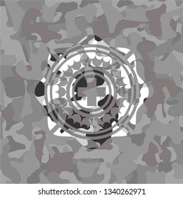 medicine icon inside grey camouflaged emblem