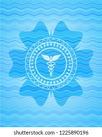 medicine icon inside sky blue water wave badge.