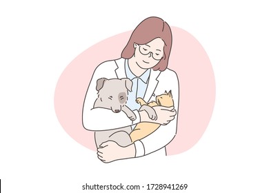 Medicine, veterinary, examination concept. Young happy smiling woman or girl veterinarian doctor cartoon character examining dog and cat puppy and kitten holding in hands. Pet check up and animal care