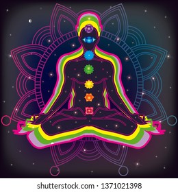 Meditating human in lotus pose in universe beside the stars. Yoga, esoterics; seven chakras and aura glow. Mandala background. 