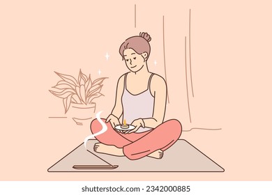 Meditating woman does yoga and uses aroma candles during spiritualistic session and sits in lotus position. Meditating girl wants to achieve awareness or get rid of psychological problems.