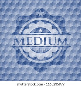 Medium blue emblem or badge with geometric pattern background.