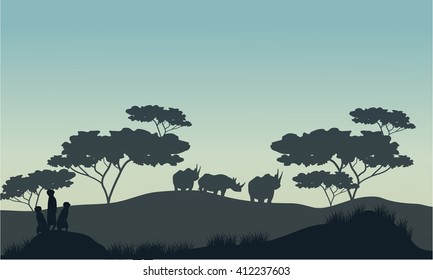 Meerkat and rhino silhouette in savannah with gray backgrounds