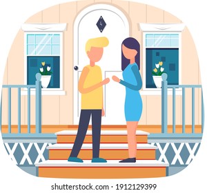 Meeting of standing young couple talking at doorstep near house. Casual guy and girl communicating outdoors. Happy relaxed man and woman spending time together on date
