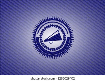 megaphone icon inside badge with denim background