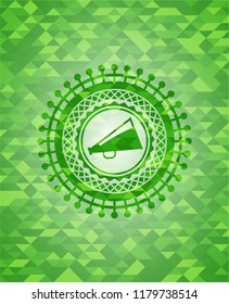 megaphone icon inside green emblem. Mosaic background