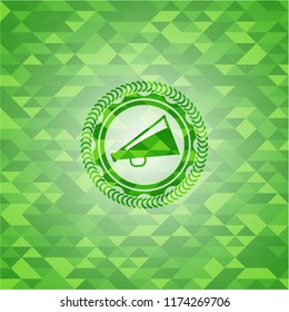 megaphone icon inside green mosaic emblem