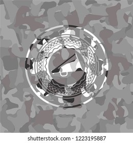megaphone icon inside grey camouflaged emblem
