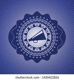 megaphone icon inside jean or denim emblem or badge background