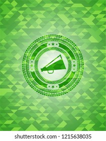 megaphone icon inside realistic green emblem. Mosaic background