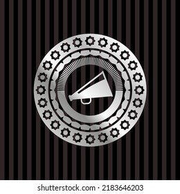 megaphone icon inside silver emblem. 