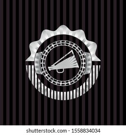 megaphone icon inside silvery emblem or badge