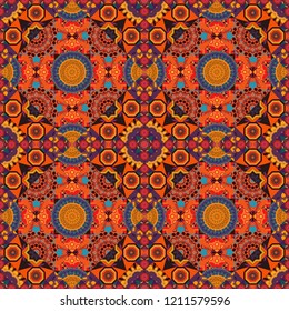 Mehndi design. Tracery seamless pattern. Vector illustration. Curved doodling in orange, red and brown colors. Ethnic binary doodle texture.