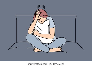 Melancholic woman is sad sitting on bed and hugging pillow after quarrel with boyfriend or divorce from husband. Melancholic girl suffers from headache causing insomnia and chronic fatigue.