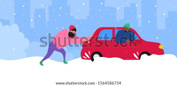 men push a\
car stuck in snow helping to a\
driver