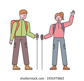 Men and women backpackers. A man and a woman are greeting with poles in their hands. flat design style minimal vector illustration.
