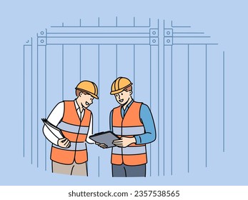 Men work in industrial field and stand near sea shipping containers discussing logistics or storage cargo. Teamwork of transport company employees dressed in industrial uniforms and hardhat