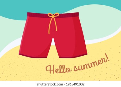 Men's swimming trunks. Red shorts on a background of sea water and sand. Hello summer. Swimming suits on vacation