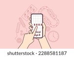Menstruation cycle calendar in mobile phone in hands near pads and tampons or feminine hygiene products and pain pills. Planning menstruation or critical days using website for girls, 