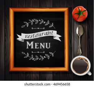 Menu on Chalkboard background with hand drawn ornament for restaurant in wooden frame on wooden background with tomato coffee and a tea spoon