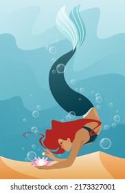 Mermaid. A red-haired mermaid girl with a green tail swims along the ocean floor with a flower in her hand. Vector illustration of mythology and fairy tales.