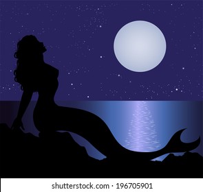 mermaid silhouette on the rocks