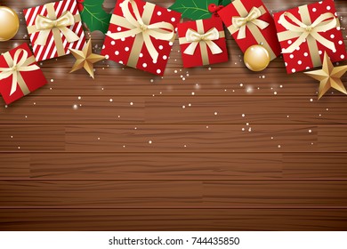 Merry christmas background design template. Gift box and gold ball on brown wooden.