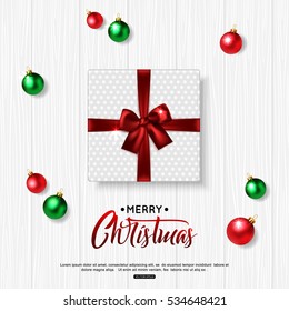 Merry Christmas background with green, red balls and gift box. Top view. Vector illustration